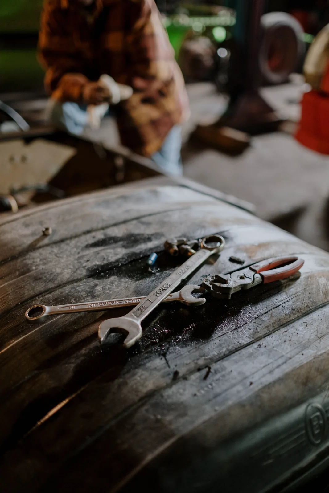 Spanners and hand tools laid out on a steel work surface